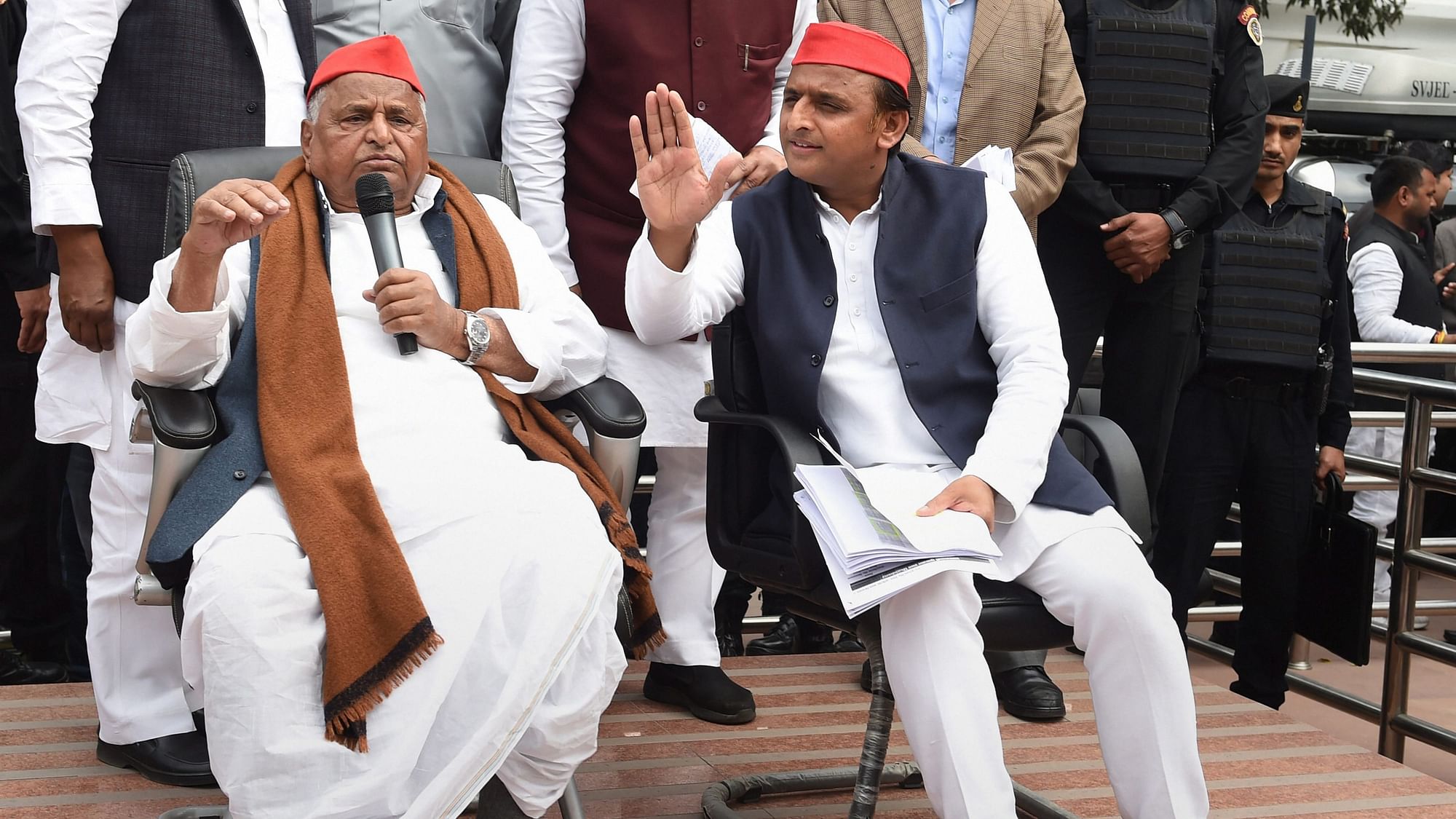 Samajwadi Party leaders Mulayam Singh Yadav and Akhilesh Yadav address their party workers, in Lucknow.