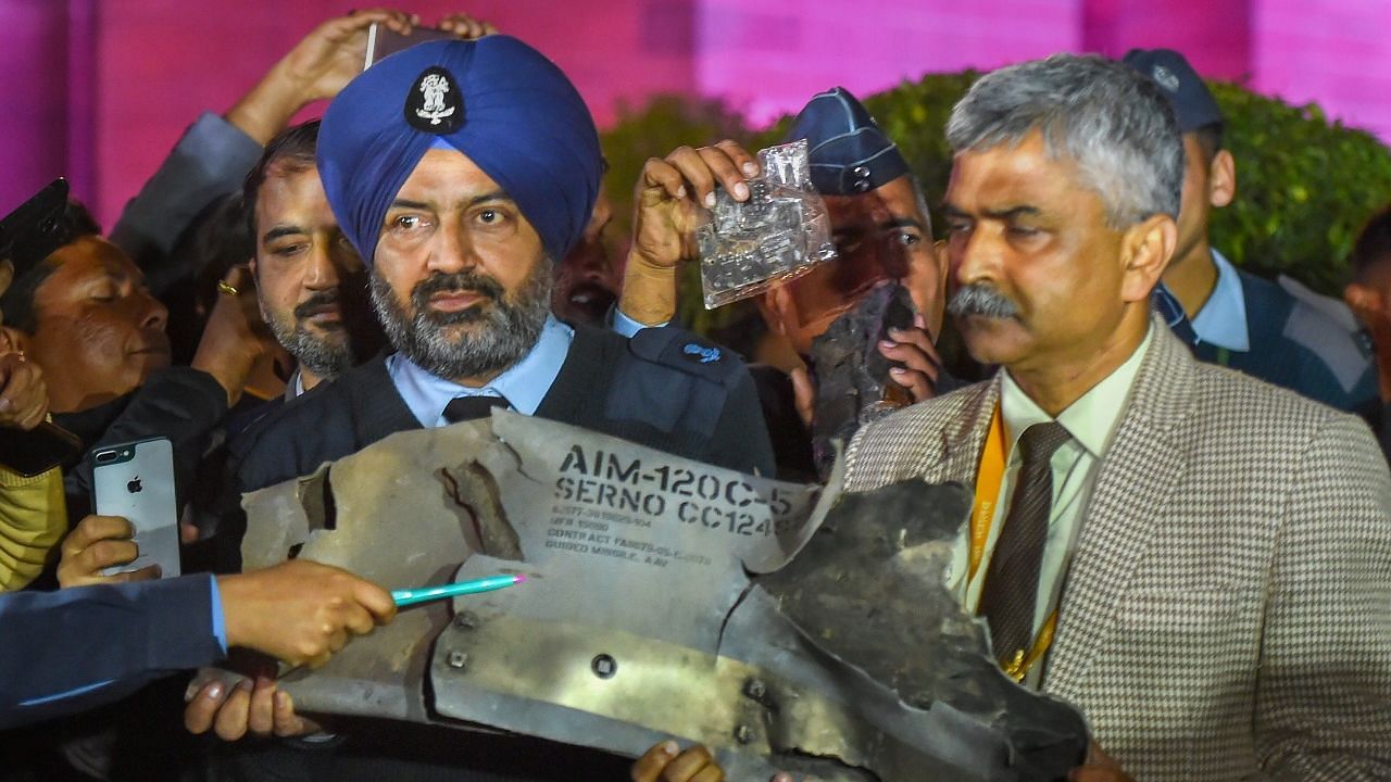 IAF officials display  parts of F-16 missile.