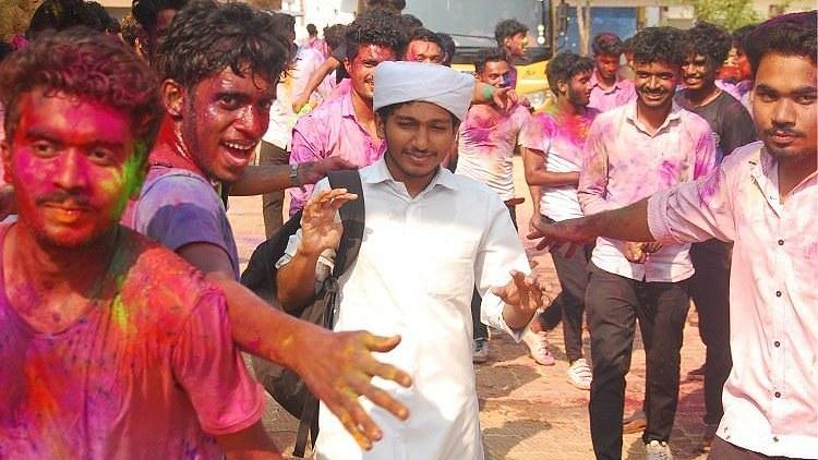 Muhammed Suhail passes through the Holi celebrations.