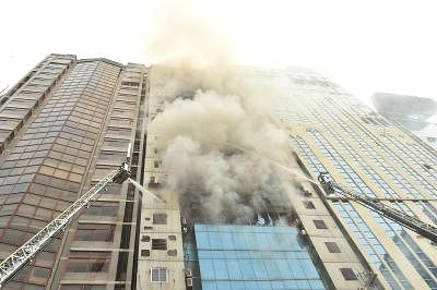 DHAKA, March 28, 2019 (Xinhua) -- Firefighters try to douse flame after a fire broke out at a high-rise building in Dhaka, Bangladesh on March 28, 2019. At least one person has died and 30 others rushed to hospital as a massive fire engulfed a high-rise building in Bangladesh capital Dhaka