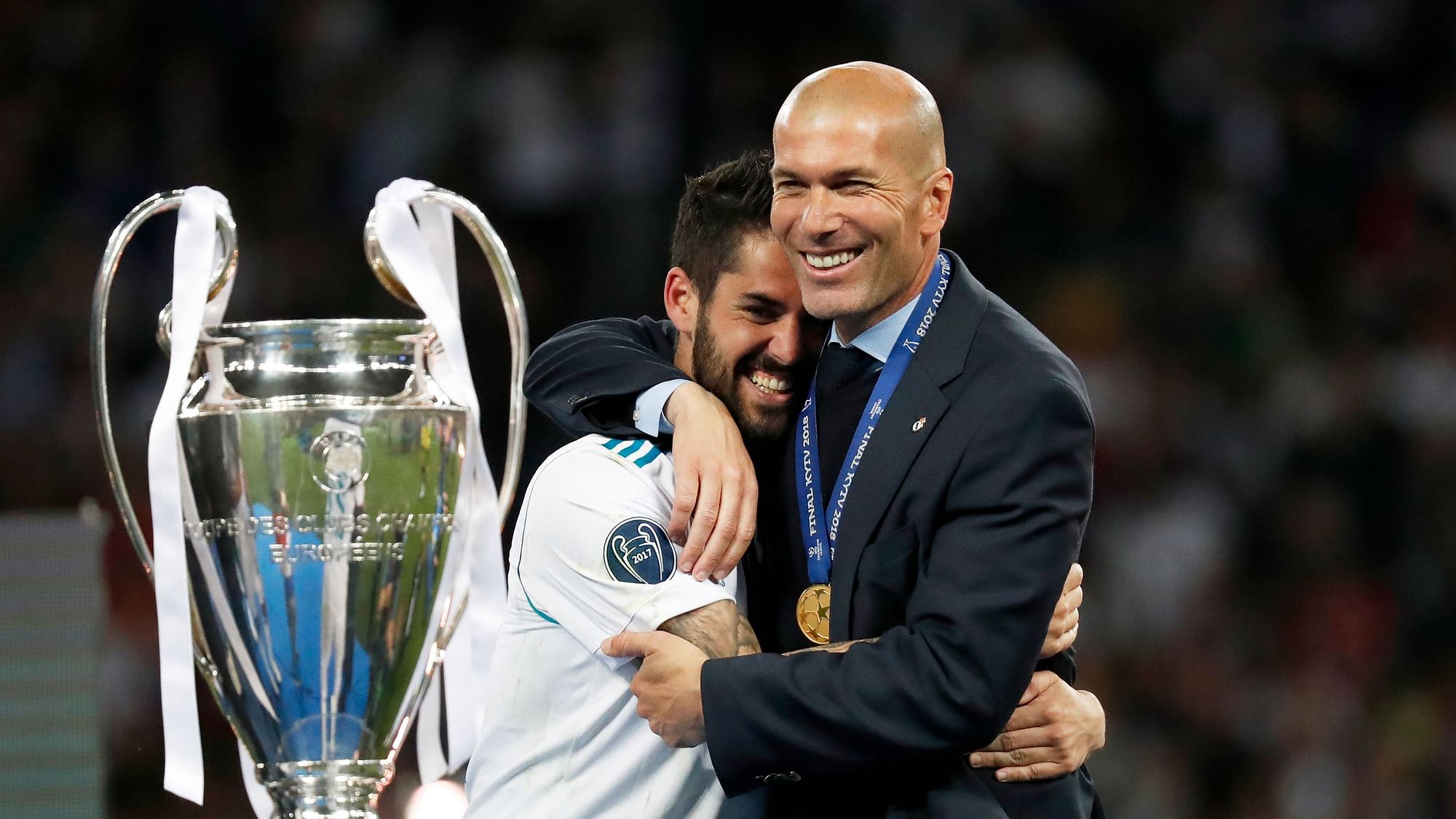 Real Madrid’s Isco hugs coach Zinedine Zidane, right, after winning the Champions League Final  at the Olimpiyskiy Stadium in Kiev, Ukraine, Saturday, May 26, 2018.&nbsp;