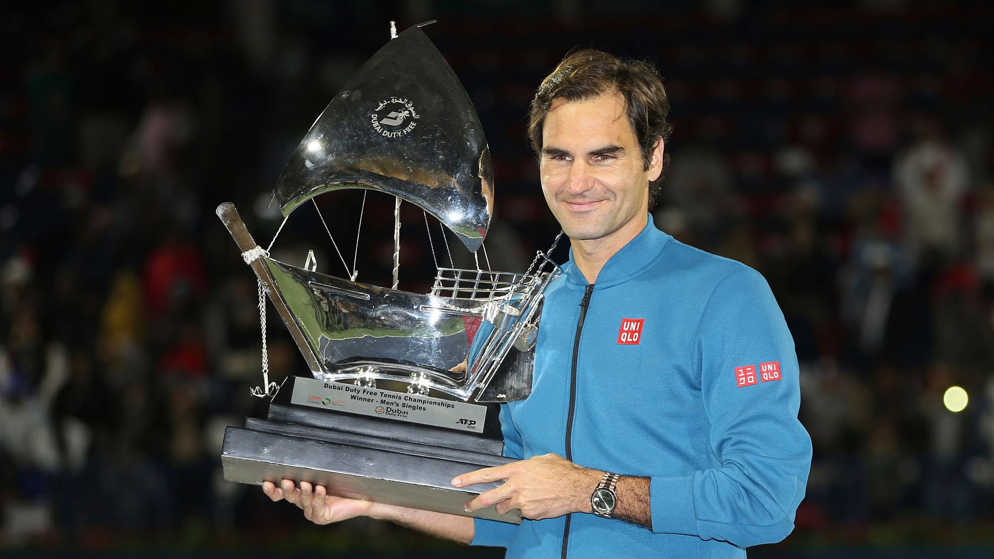 Roger Federer of Switzerland holds his trophy after winning the final match at the Dubai Duty Free Tennis Championship against Stefanos Tsitsipas of Greece in Dubai, on Saturday.