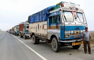 Pulwama: Trucks remain stranded on Jammu-Srinagar Highway at Pampore after protesters pelted stones at Lethpora, Awantipora in Jammu and Kashmir