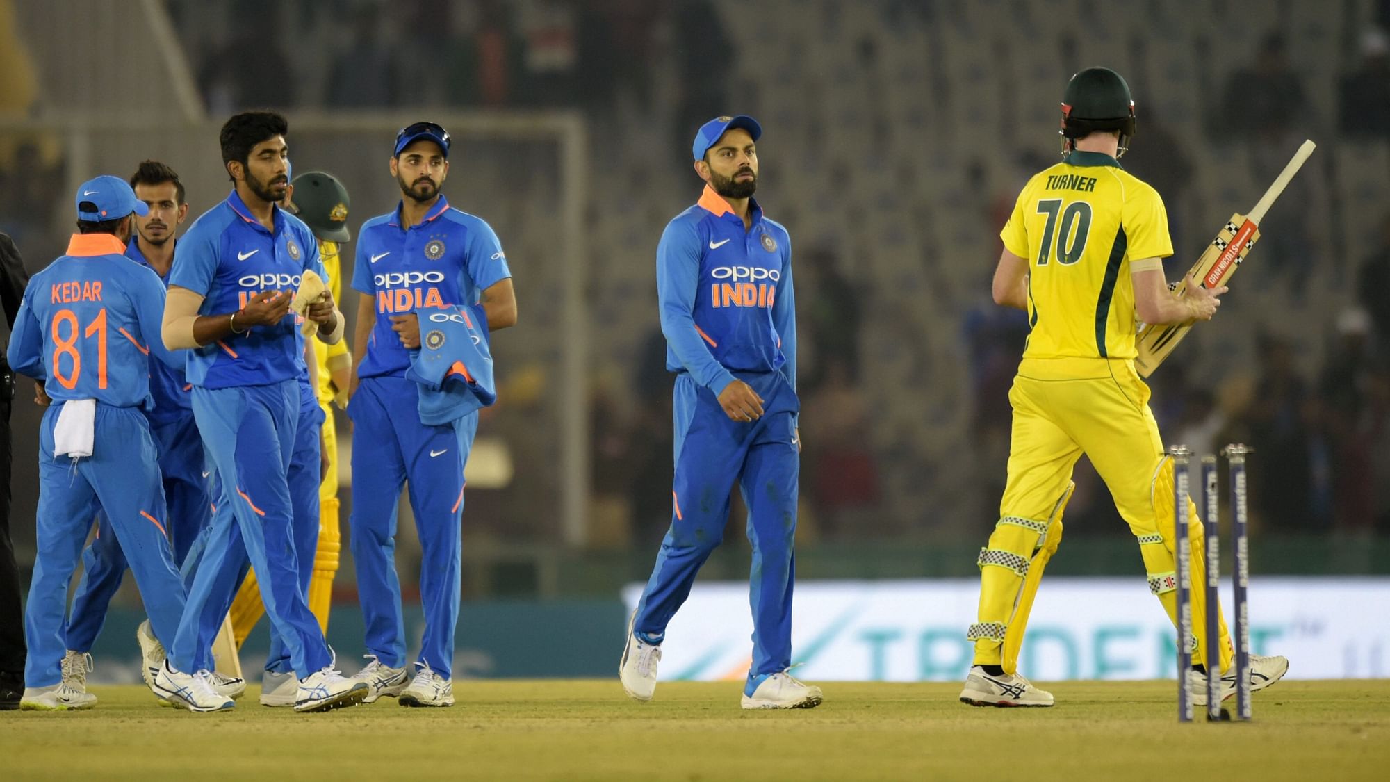 Indian skipper Virat Kohli along with teammates walk off the field after losing 4th ODI cricket match against Australia, in Mohali on 10 March 2019.