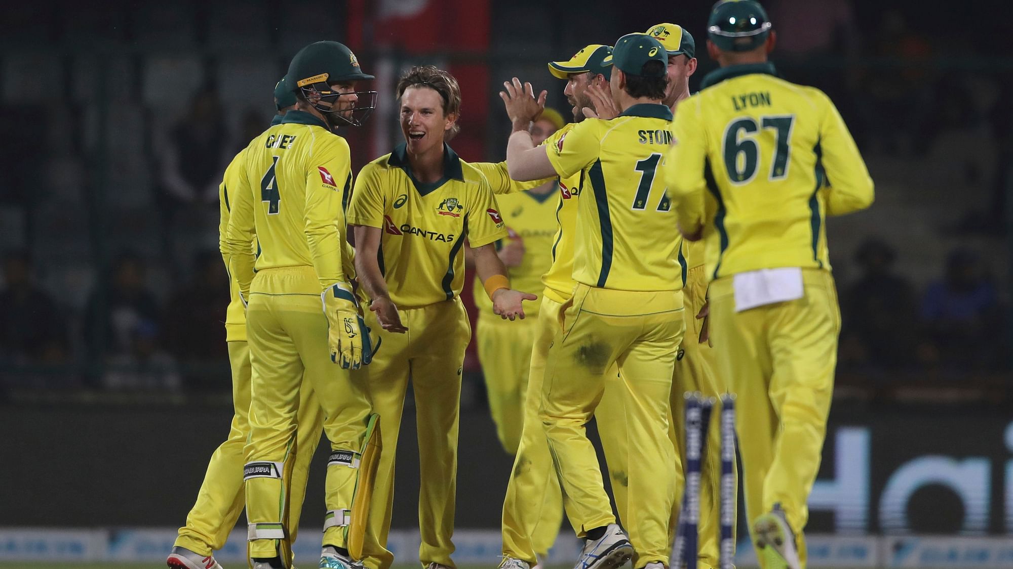 Australian players celebrate the fall of a wicket during their series-deciding fifth ODI against India at New Delhi.