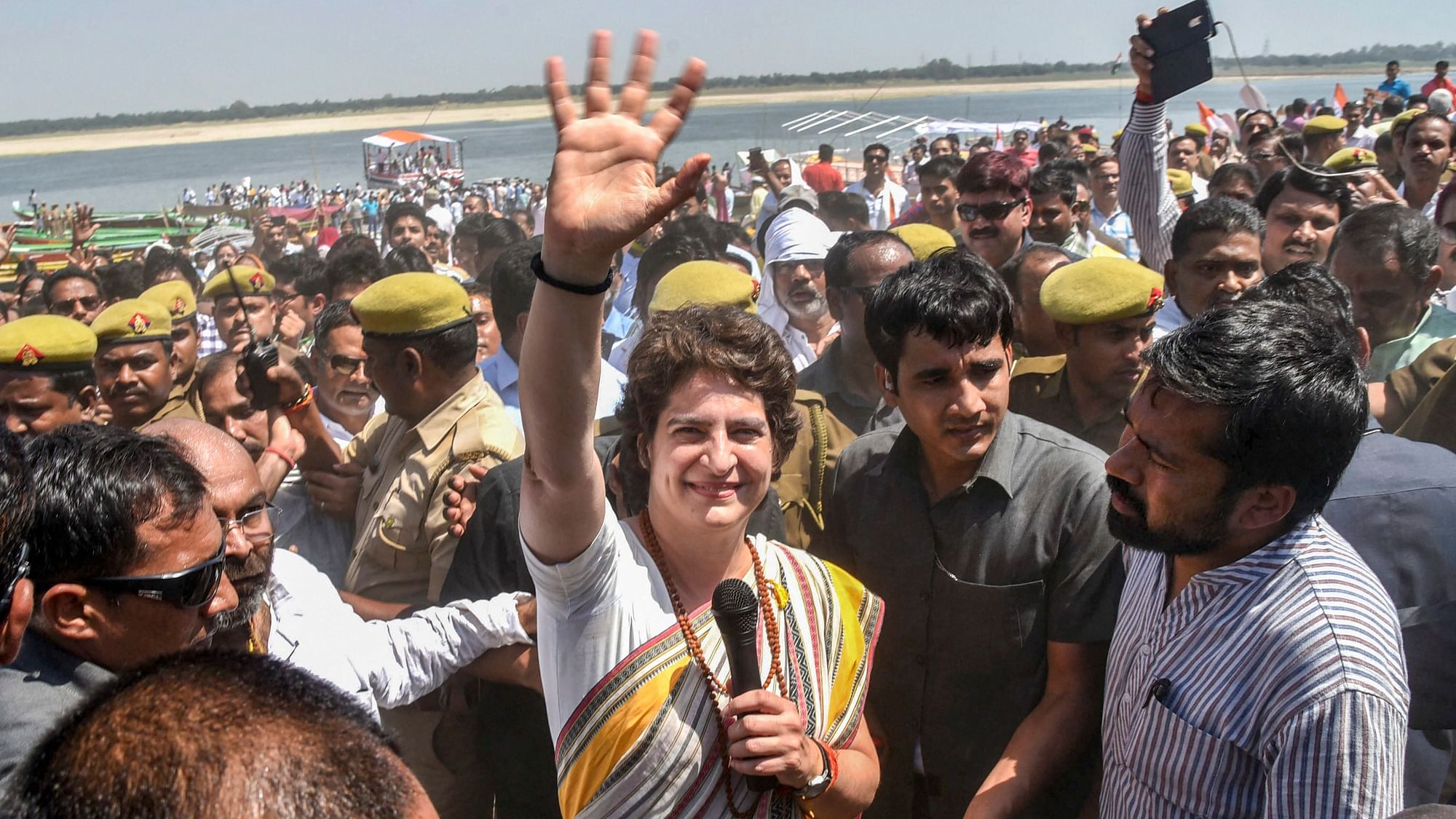 Congress General Secretary UP (East) Priyanka Gandhi Vadra waves to her party supporters at Assi Ghat, in Varanasi.