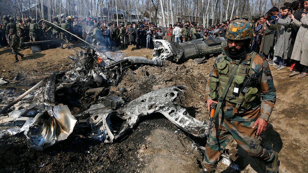Indian Army soldiers arrive at the wreckage of an an Indian helicopter after it crashed in Budgam area, outskirts of Srinagar on Wednesday, 27 February, 2019.&nbsp;