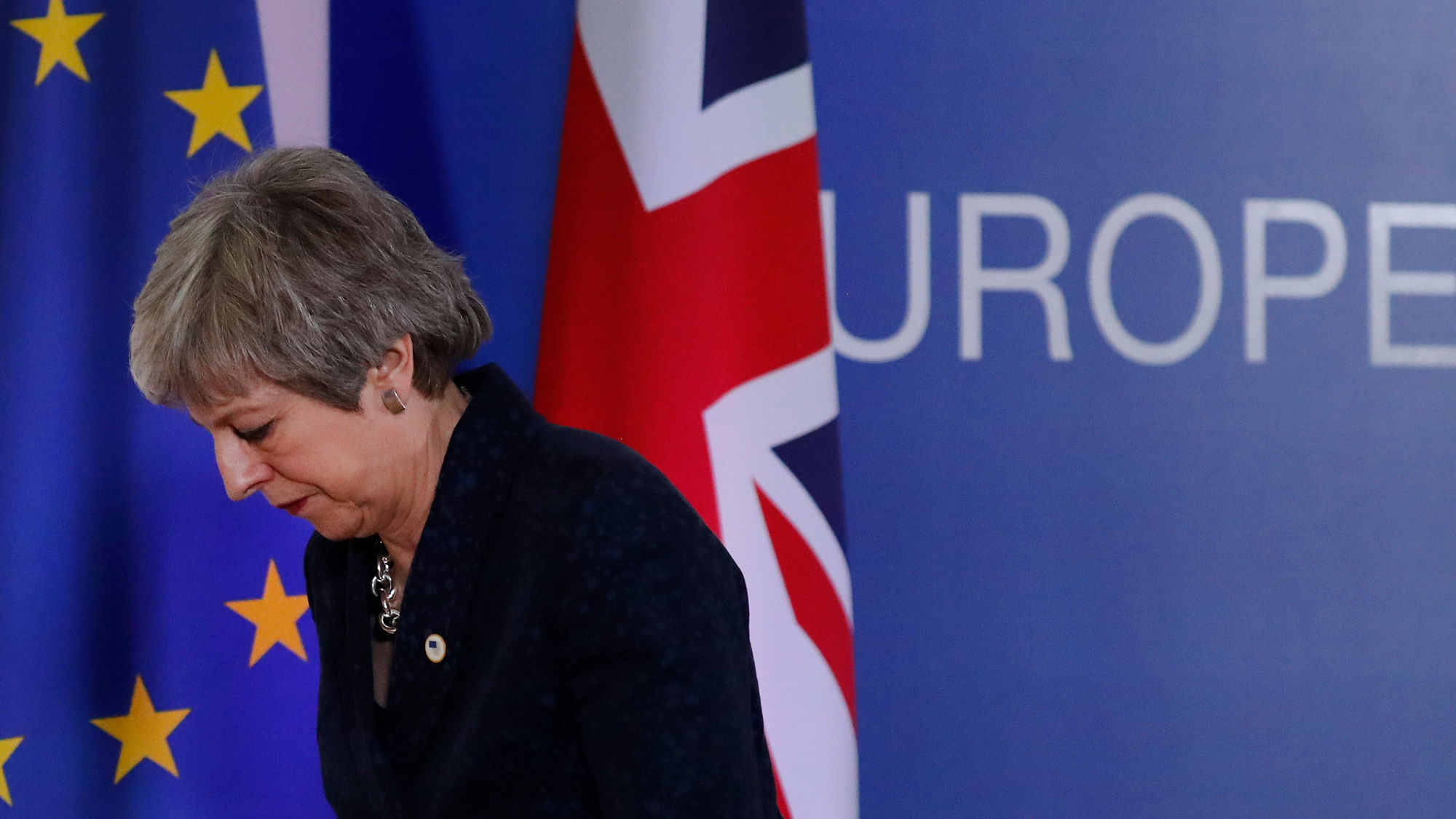 British PM Theresa May leaves after addressing a media conference at an EU summit in Brussels, Friday, 22 March.