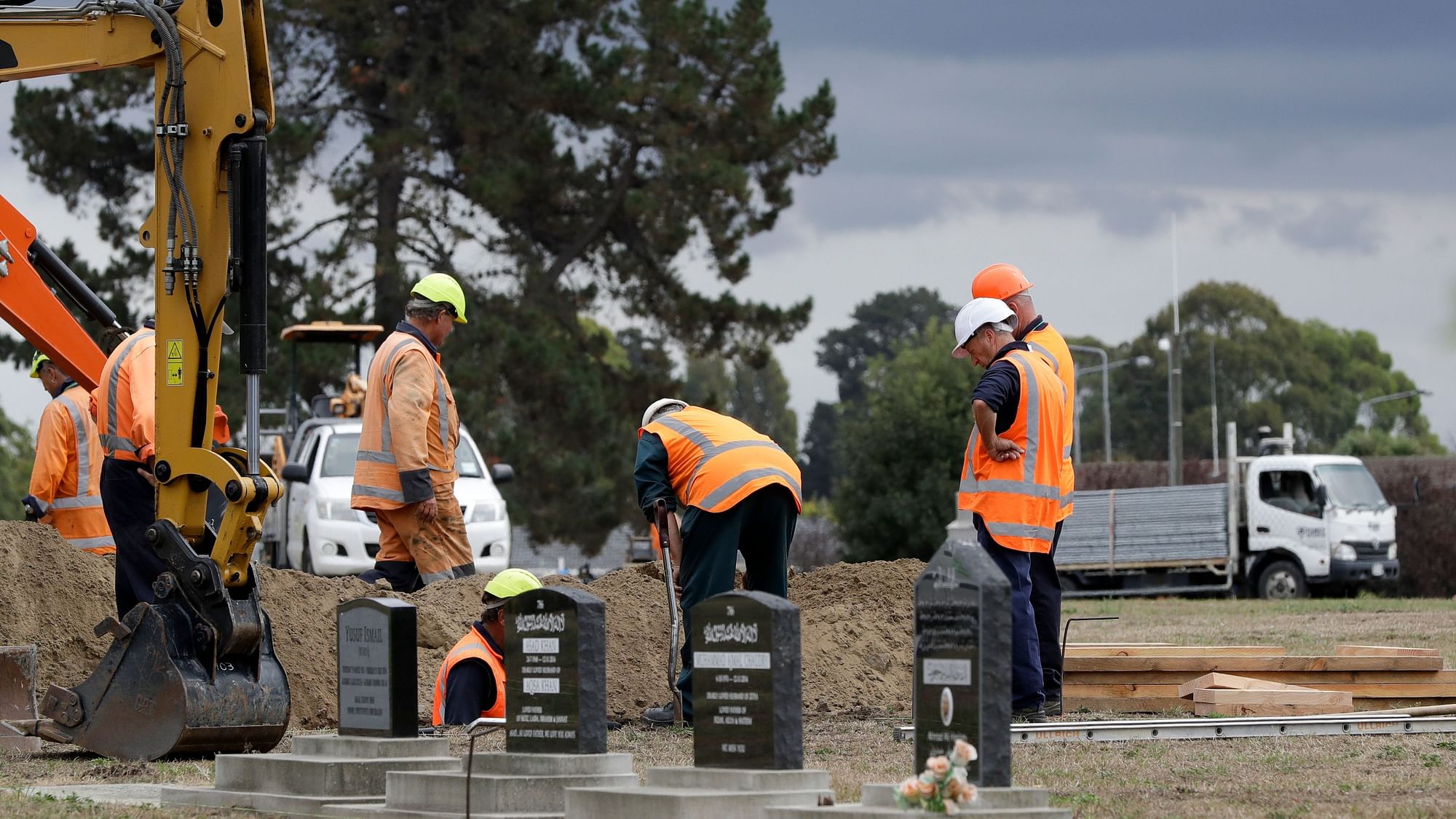 Workers dig graves at a Muslim cemetery in Christchurch, New Zealand, Saturday, 16 March 2019, for victims of a mass shooing at two area mosques.