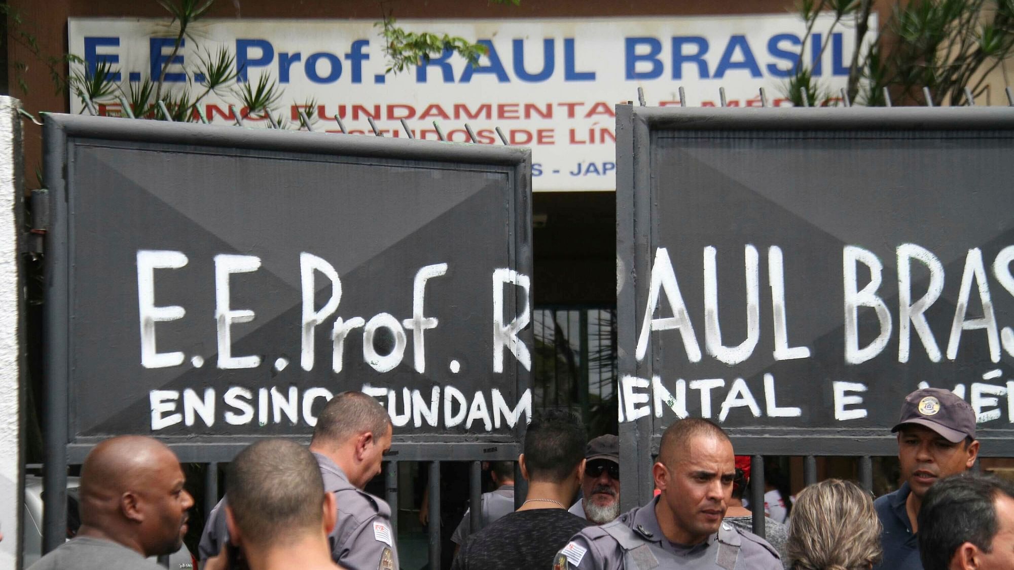 Police officers guard the entrance of the Raul Brasil State School in Suzano, Brazil, where a shooting took place early on Wednesday.