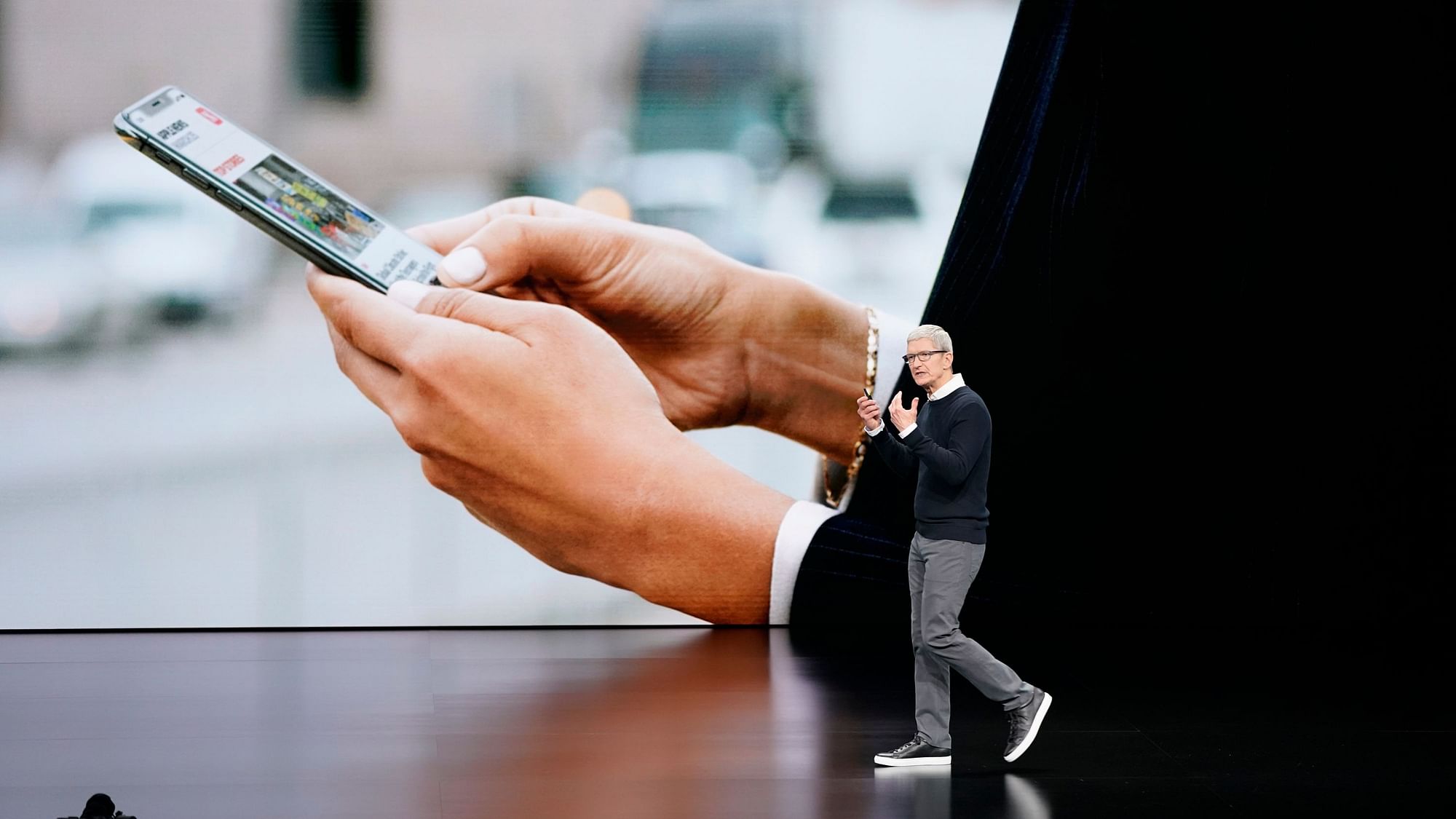 Apple CEO Tim Cook speaks at the Steve Jobs Theater during an event to announce new products.