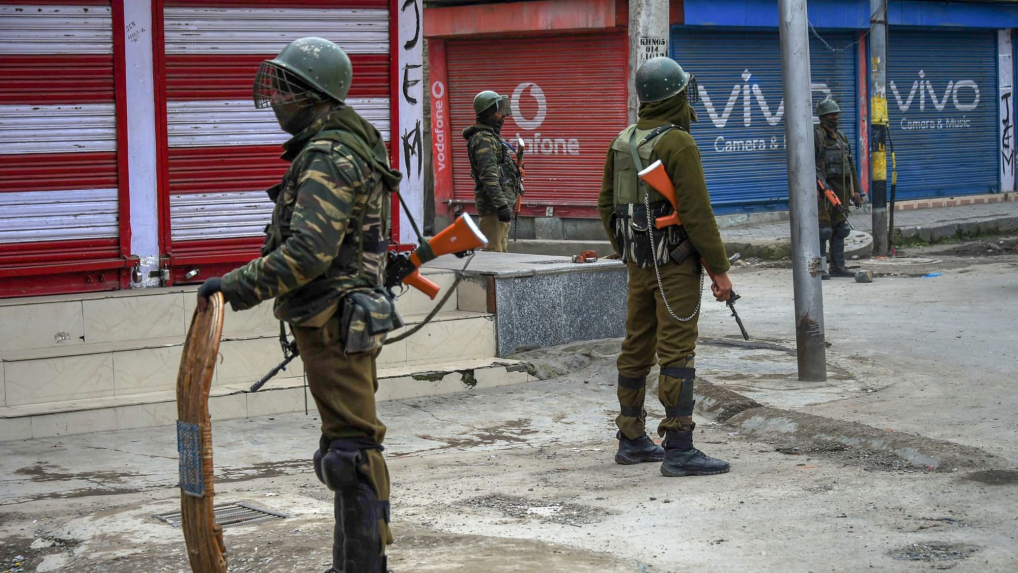 Security personnel stand guard during restrictions in Srinagar on 1 March.&nbsp;