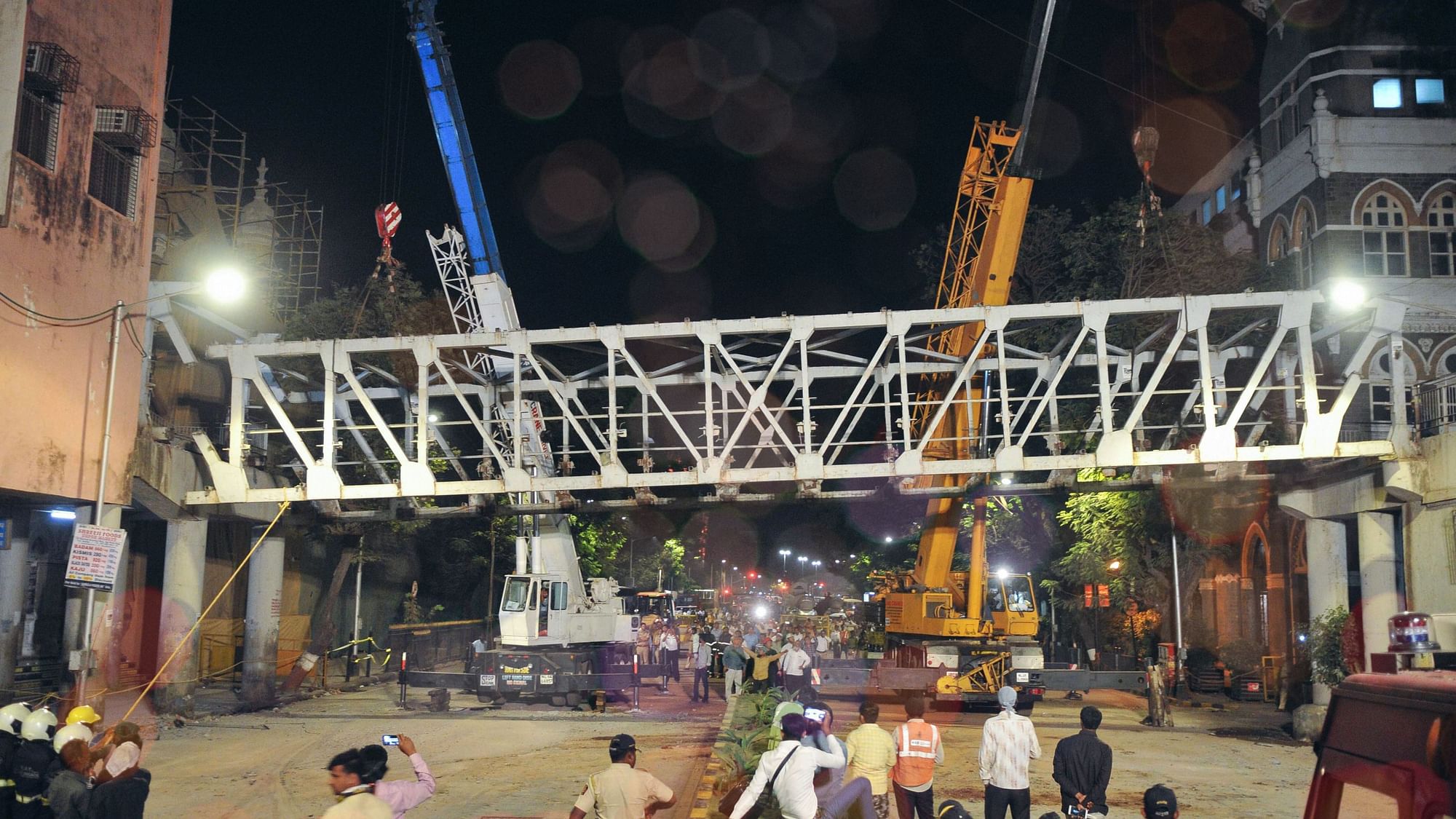 In this picture from 15 March, 2019, civic authorities are seen dismantling the bridge connecting the CST station and the are&nbsp; ear the TOI building, after it collapsed 14 March.