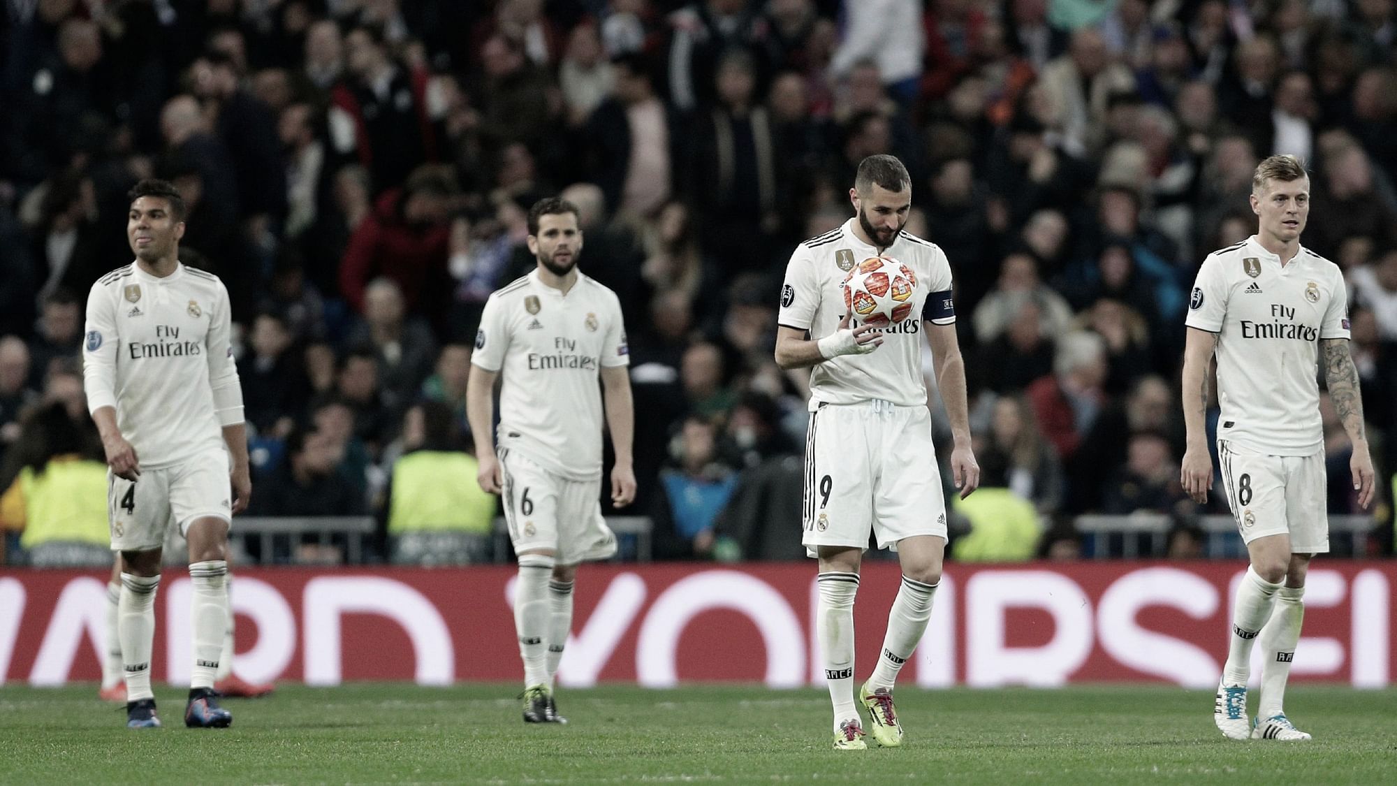 Down, and out: Real Madrid players cut a forlorn figure during their defeat to Ajax, which saw them crash out of the UEFA Champions League.