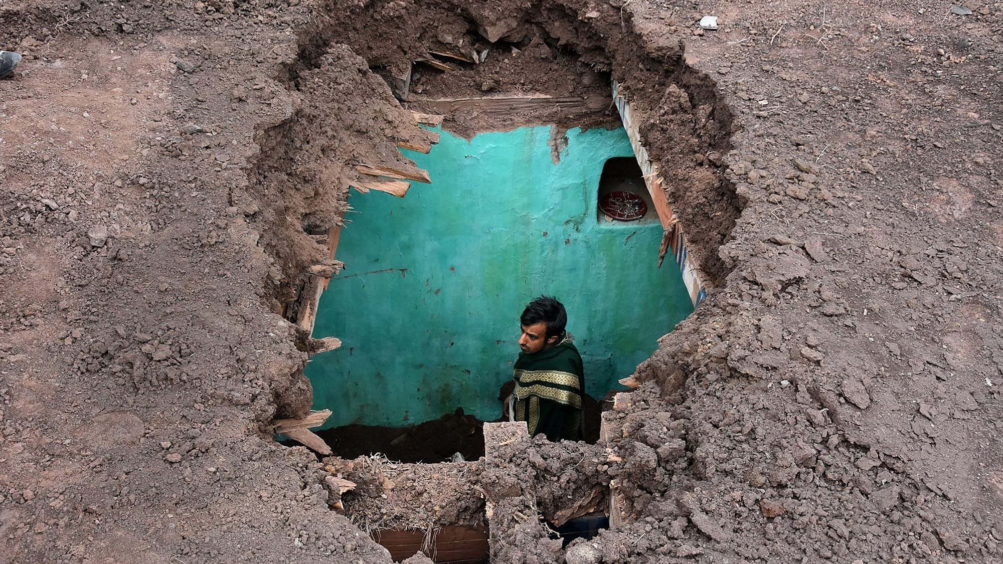 A villager stands inside his damaged house after heavy shelling from the Pakistani side at Mendhar, in Poonch district on Friday, 1 March 2019.
