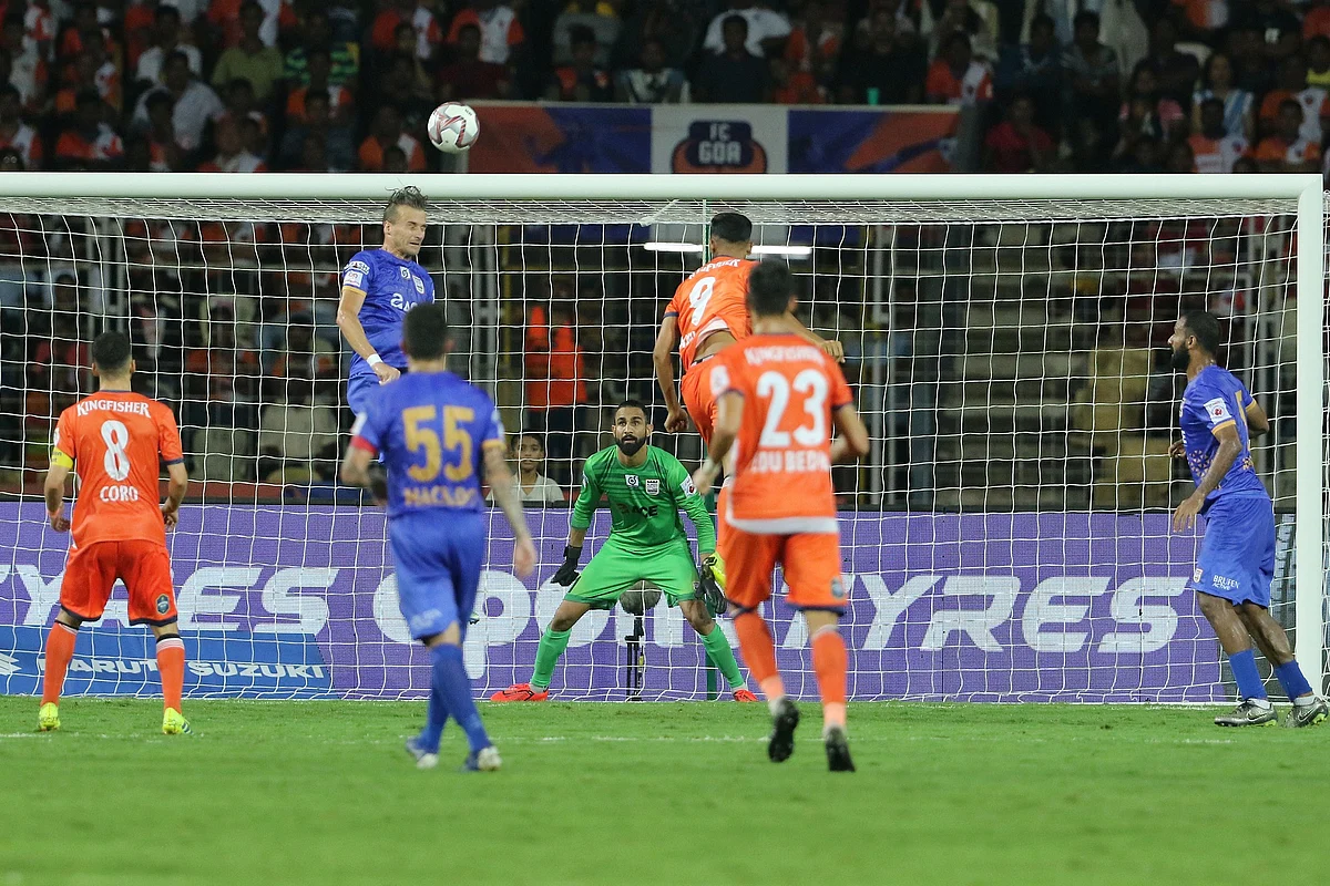 Lucian Goian of Mumbai City FC heads the ball against FC Goa in ISL.