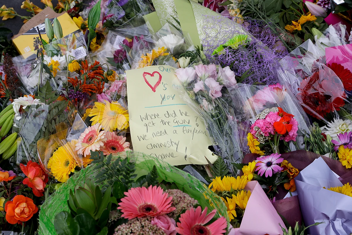 A handwritten message is placed at a makeshift memorial near the Masjid Al Noor mosque in Christchurch, New Zealand, Saturday, March 16, 2019, where one of the two mosque mass shootings at occurred.