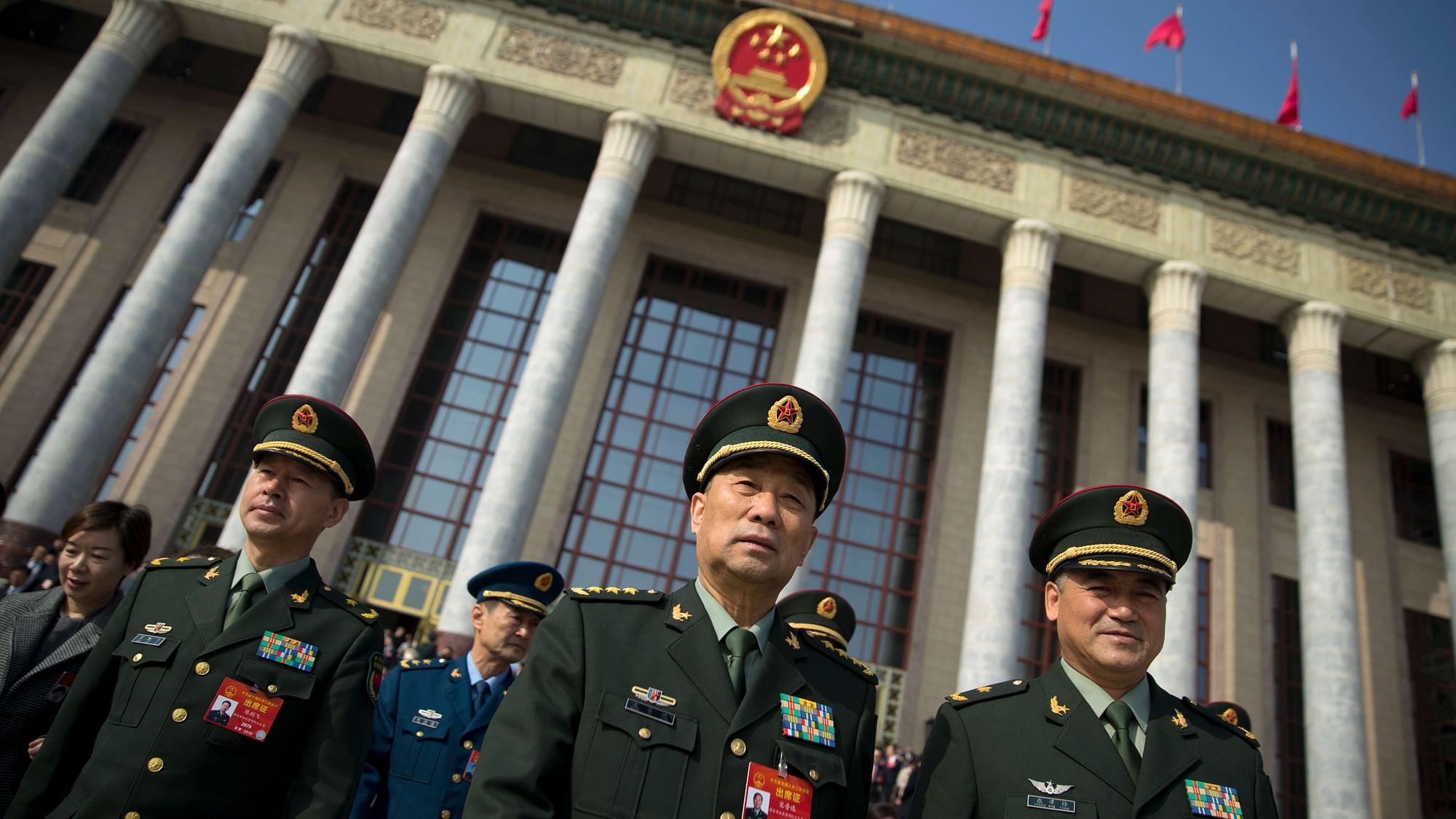 In this 4 March 2019 photo, military delegates leave after a meeting one day before the opening session of China’s National People’s Congress (NPC) at the Great Hall of the People in Beijing. To a remarkable degree, the Pentagon’s new budget proposal is shaped by national security threats that Acting Defense Secretary Patrick Shanahan has summarized in three words: “China, China, China.”
