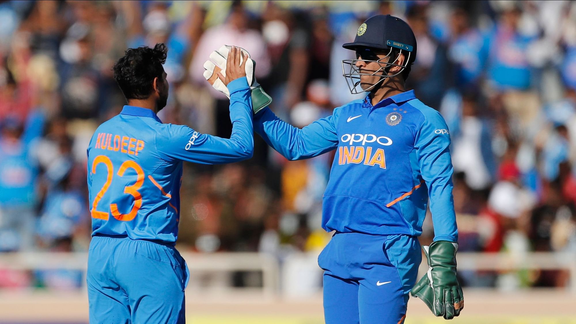 MS Dhoni celebrates a wicket with Kuldeep Yadav during the third ODI between India and Australia at Ranchi.