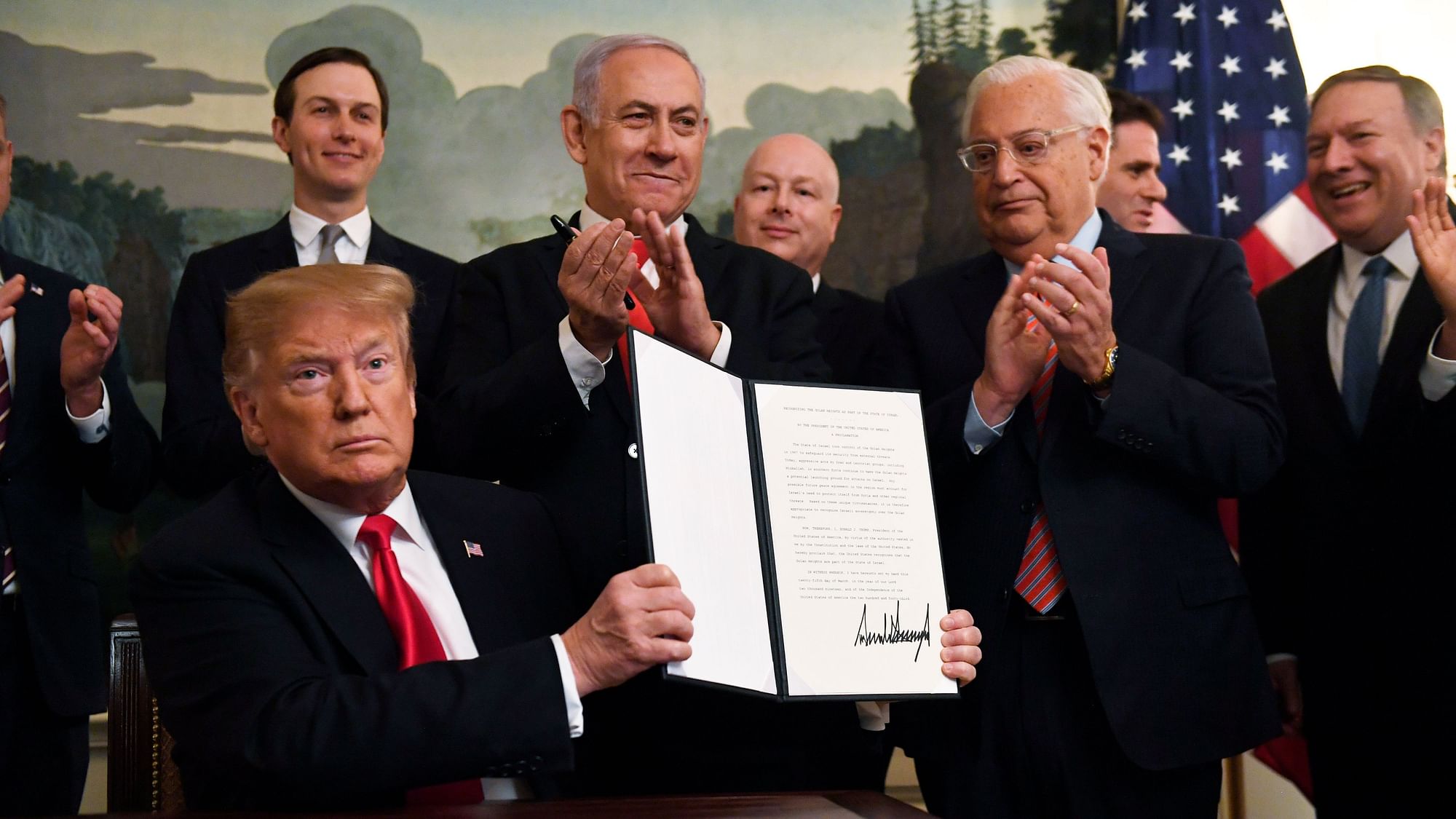 President Donald Trump holds up a signed proclamation recognising Israel’s sovereignty over the Golan Heights