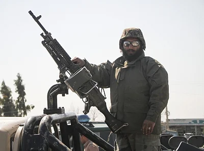 NANGARHAR, March 6, 2019 (Xinhua) -- An Afghan security force member stands on a military vehicle near the site of an attack in Nangarhar province, Afghanistan, March 6, 2019. A total of 21 people including five attackers were killed and nine others injured as a blast followed by gun shots rocked Jalalabad city, the capital of eastern Nangarhar province on Wednesday, provincial government spokesman Attaullah Khogiani said. (Xinhua/Saifurahman Safi/IANS)
