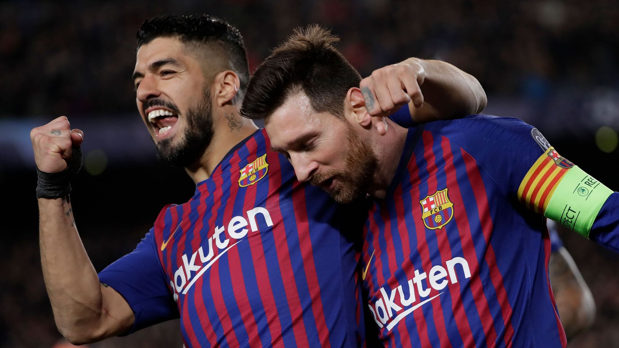 Barcelona’s Lionel Messi, right and Barcelona’s Luis Suarez celebrate after Messi scored his side’s third goal during the Champions League Round of 16, 2nd leg match between FC Barcelona and Olympique Lyon at the Camp Nou stadium.