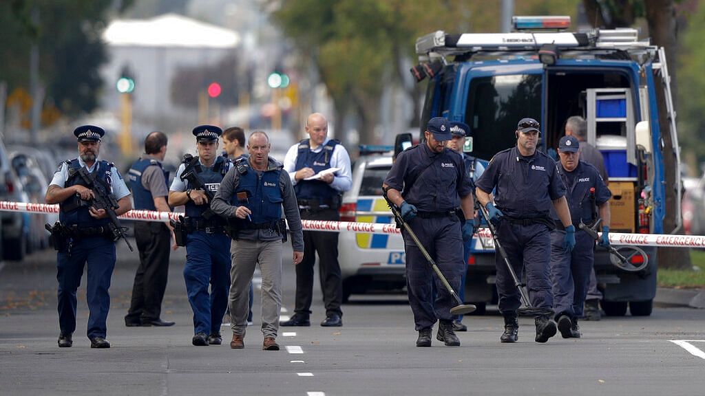 Police officers search the area near the Masjid Al Noor mosque, site of one of the mass shootings at two mosques in Christchurch, New Zealand on 16 March 2019.&nbsp;