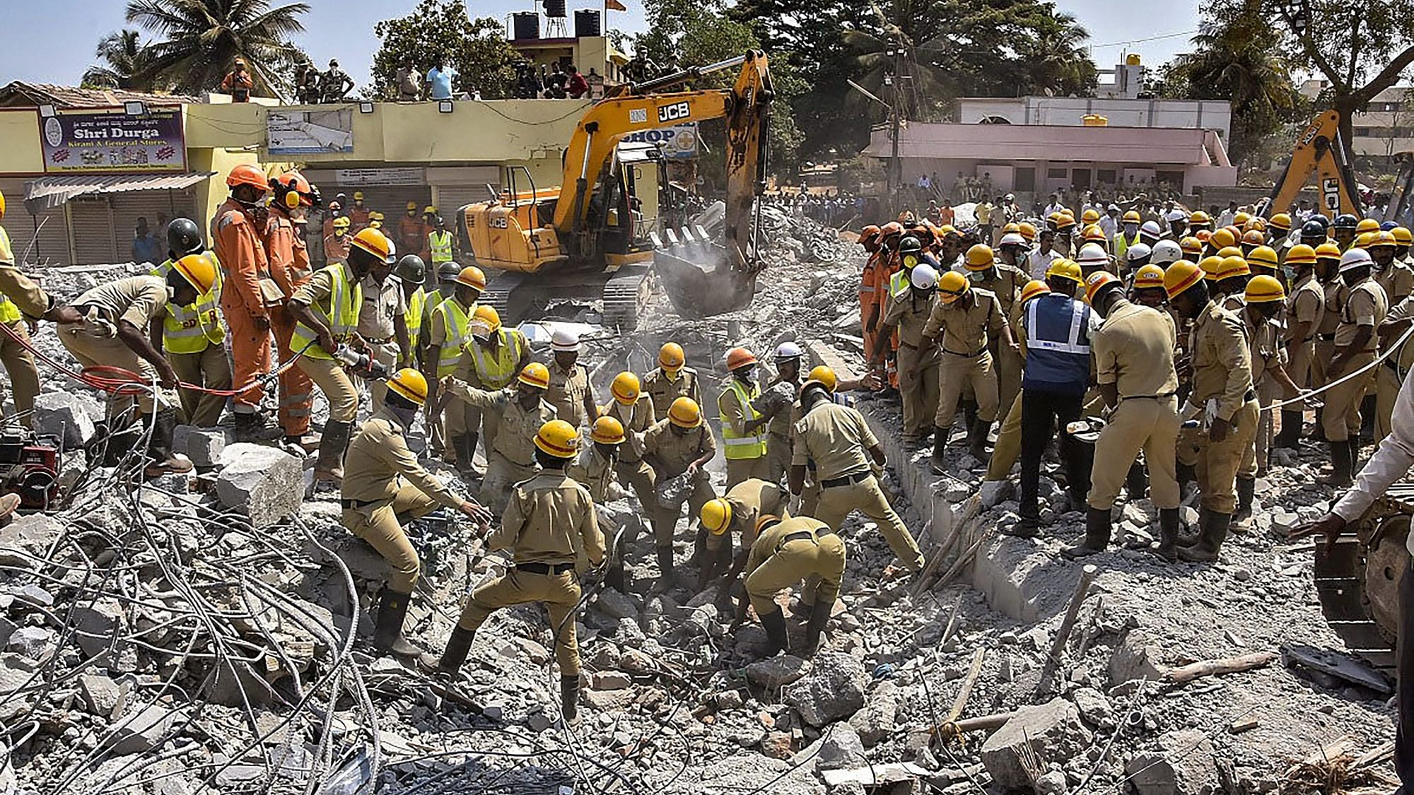 Rescue teams conduct operations after an under-construction building collapsed, at Dharwad in north Karnataka, Thursday, 21 March 2019.