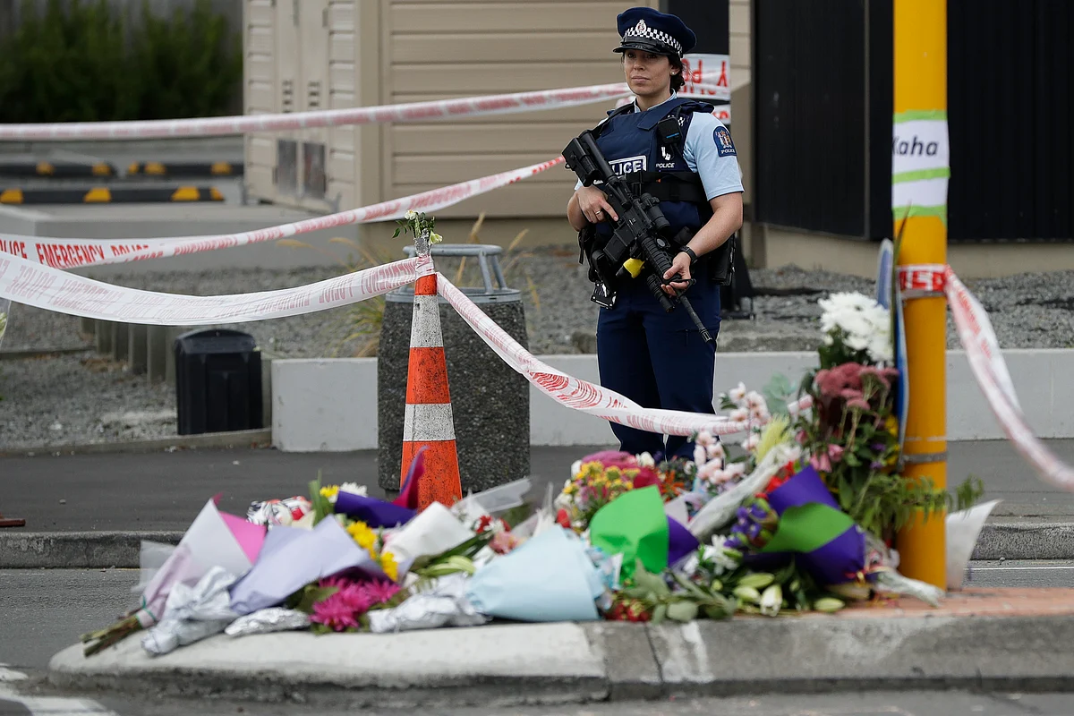 Police stand by makeshift memorial near the Linwood Mosque in Christchurch, New Zealand, Saturday, 16 March 2019, where one of the two mass shootings occurred.