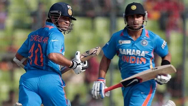 File picture of Sachin Tendulkar (left) and Virat Kohli batting at the crease together.