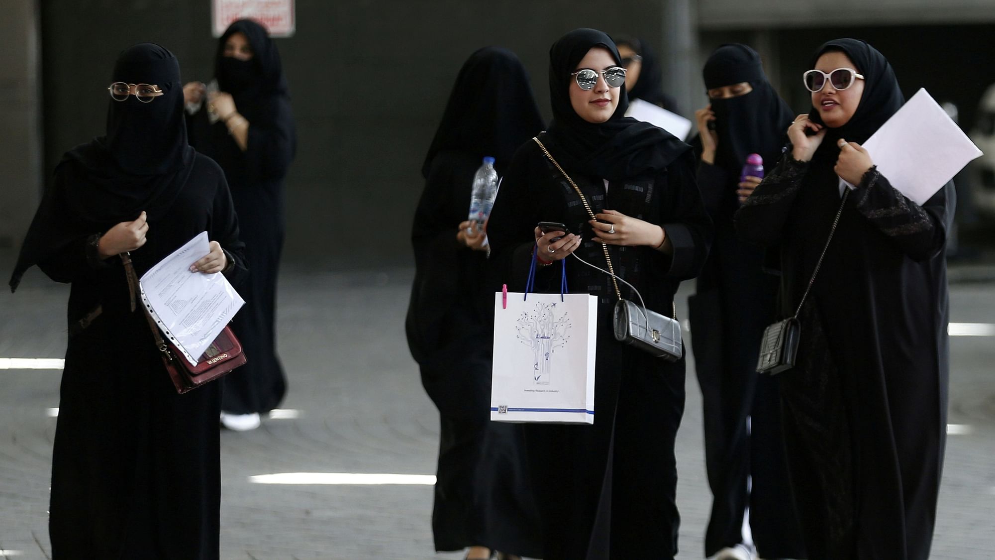 Saudi students walk at the exhibition to guide job seekers at Glowork Women’s Career Fair in Riyadh, Saudi Arabia, 2 October, 2018. 