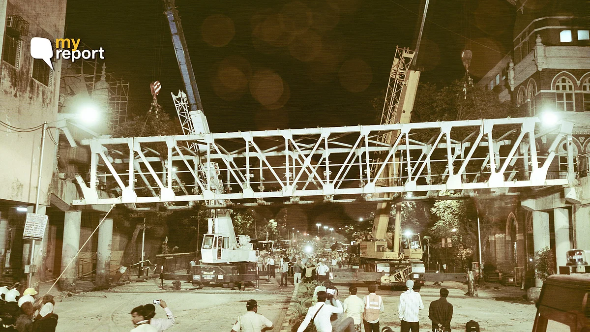 In this picture from 15 March, 2019, civic authorities are seen dismantling the bridge connecting the CST station and the are ear the TOI building, after it collapsed 14 March.