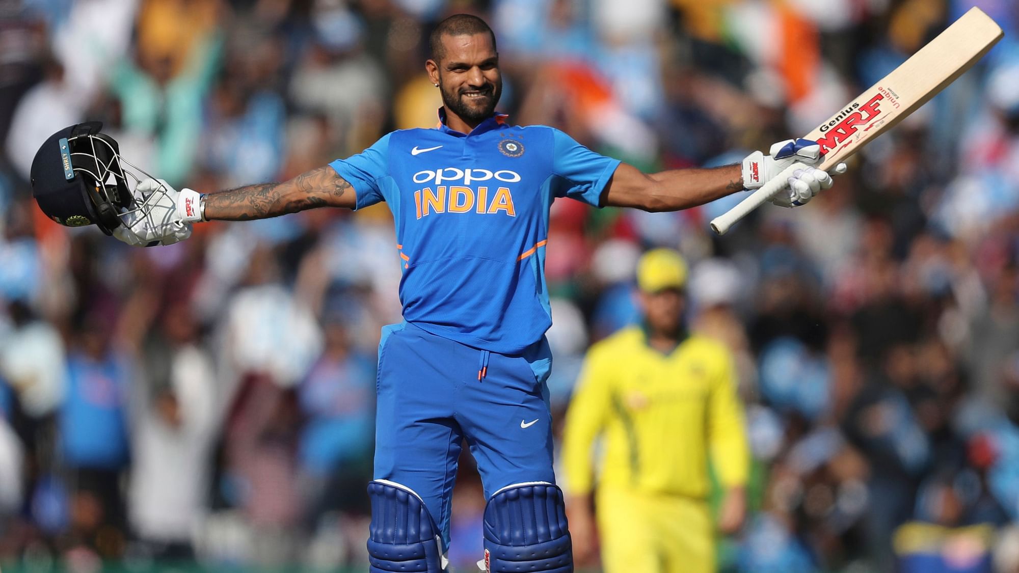 Shikhar Dhawan celebrates after reaching his 100 during the fourth ODI between India and Australia at Mohali.