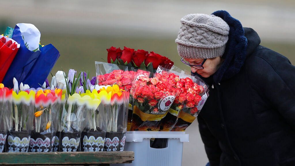 An elderly woman smells the flowers at a street market on the eve of the International Women’s Day in Minsk, Belarus on 7 March 2019.&nbsp;