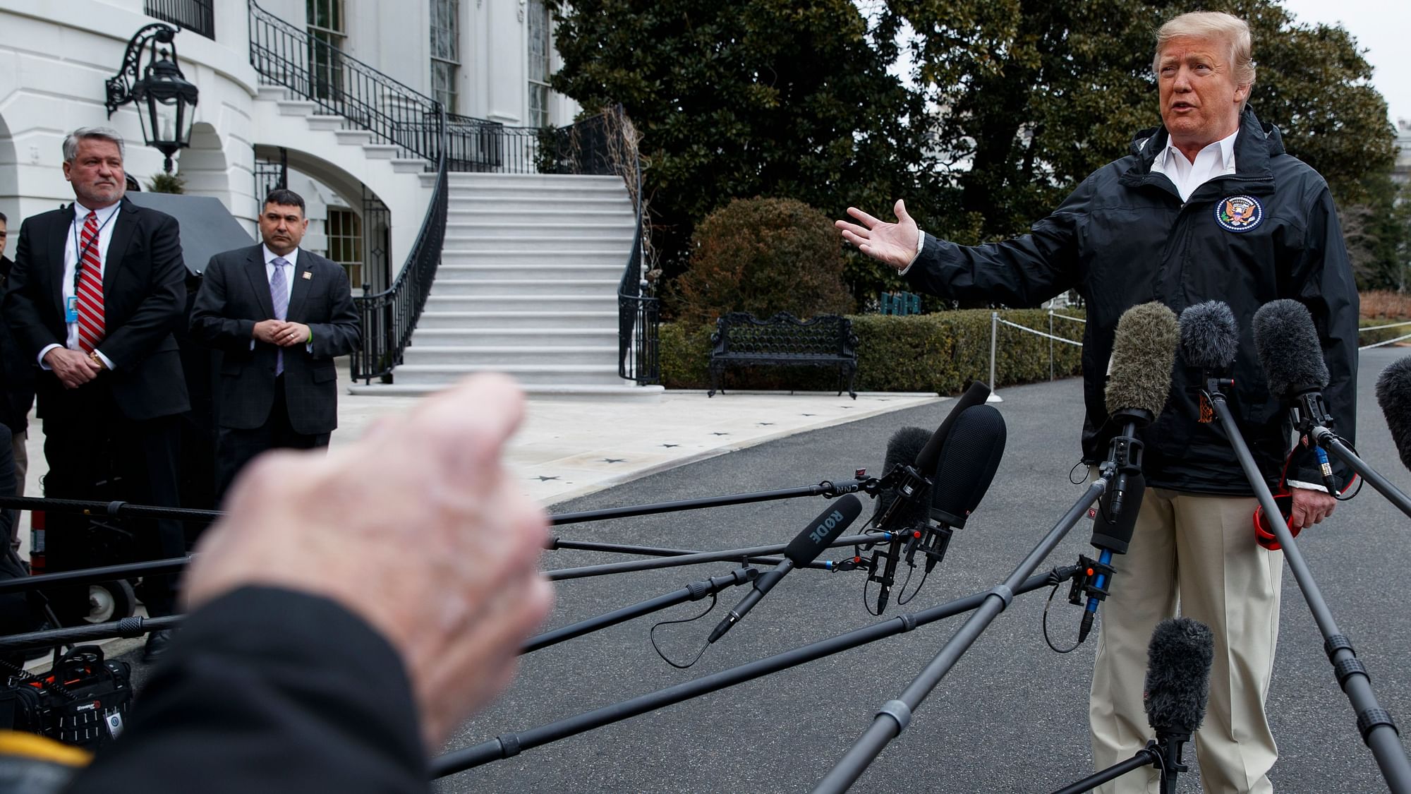 White House deputy chief of staff for communications Bill Shine, left, looks on as President Donald Trump talks with reporters outside the White House, Friday, March 8, 2019, in Washington.