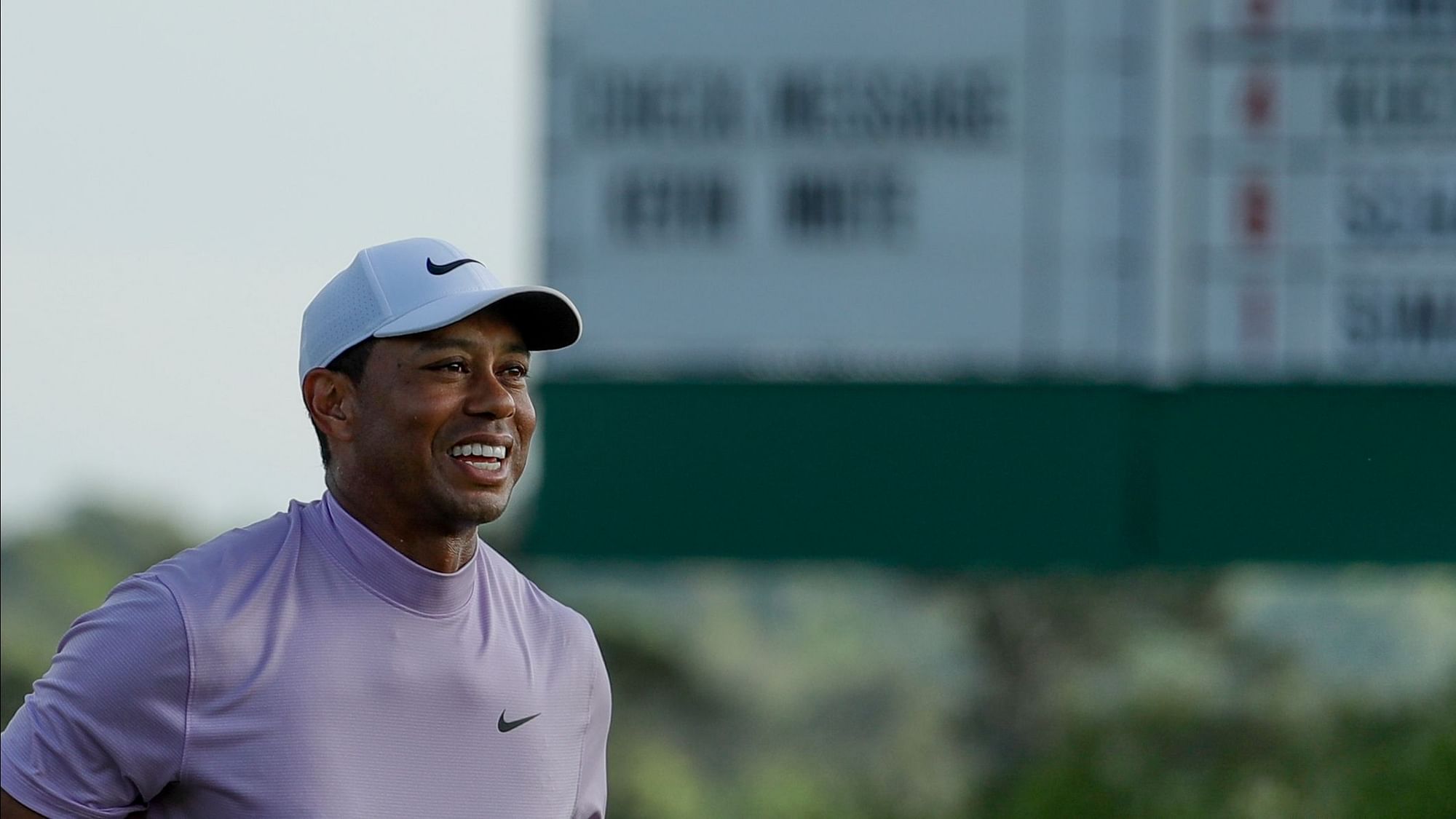 Tiger Woods smiles as he walks off the 18th green during the third round for the Masters golf tournament Saturday, April 13, 2019, in Augusta, Ga.&nbsp;