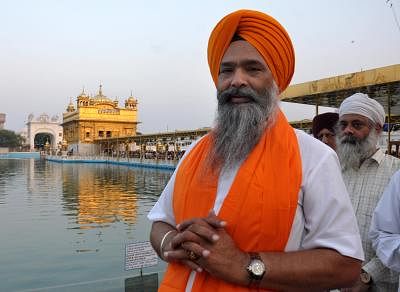 Shiromani Akali Dal leader Prem Singh Chandumajra pays obeisance at the Golden Temple after winning Anandpur Sahib Lok Sabha seat, in Amritsar on May 19, 2014. (Photo: IANS)