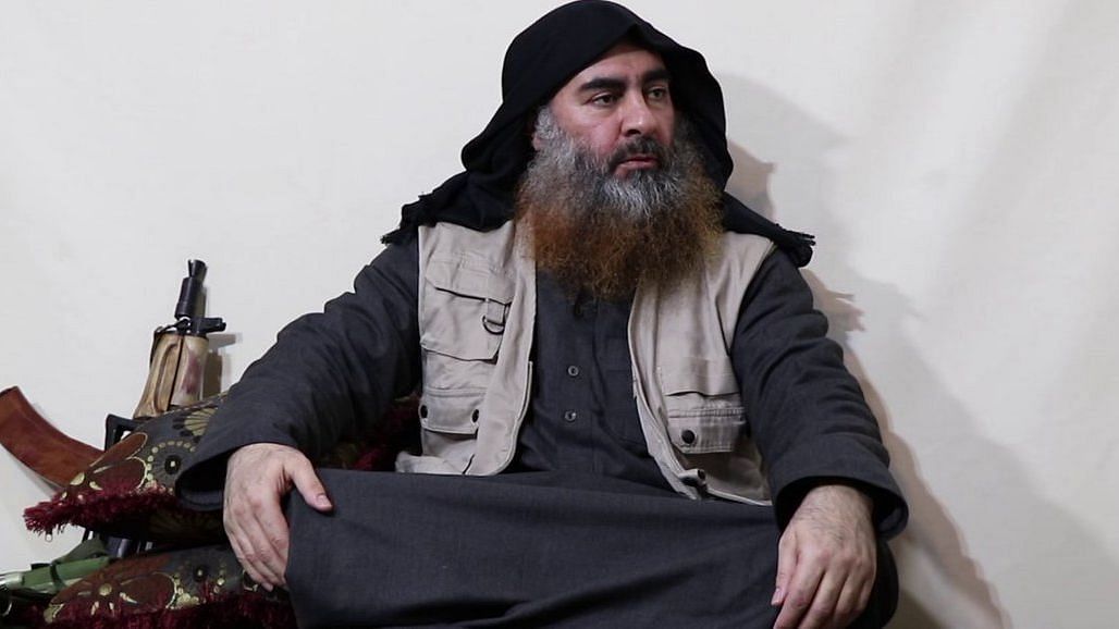 The video shows Baghdadi sitting on a couch dressed in black, talking to three others whose faces cannot be seen.