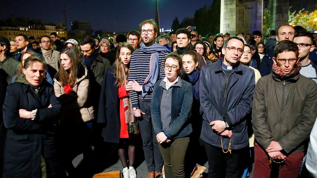 Crowds sing ‘Ave Maria’ in tribute, as Notre Dame burns.&nbsp;