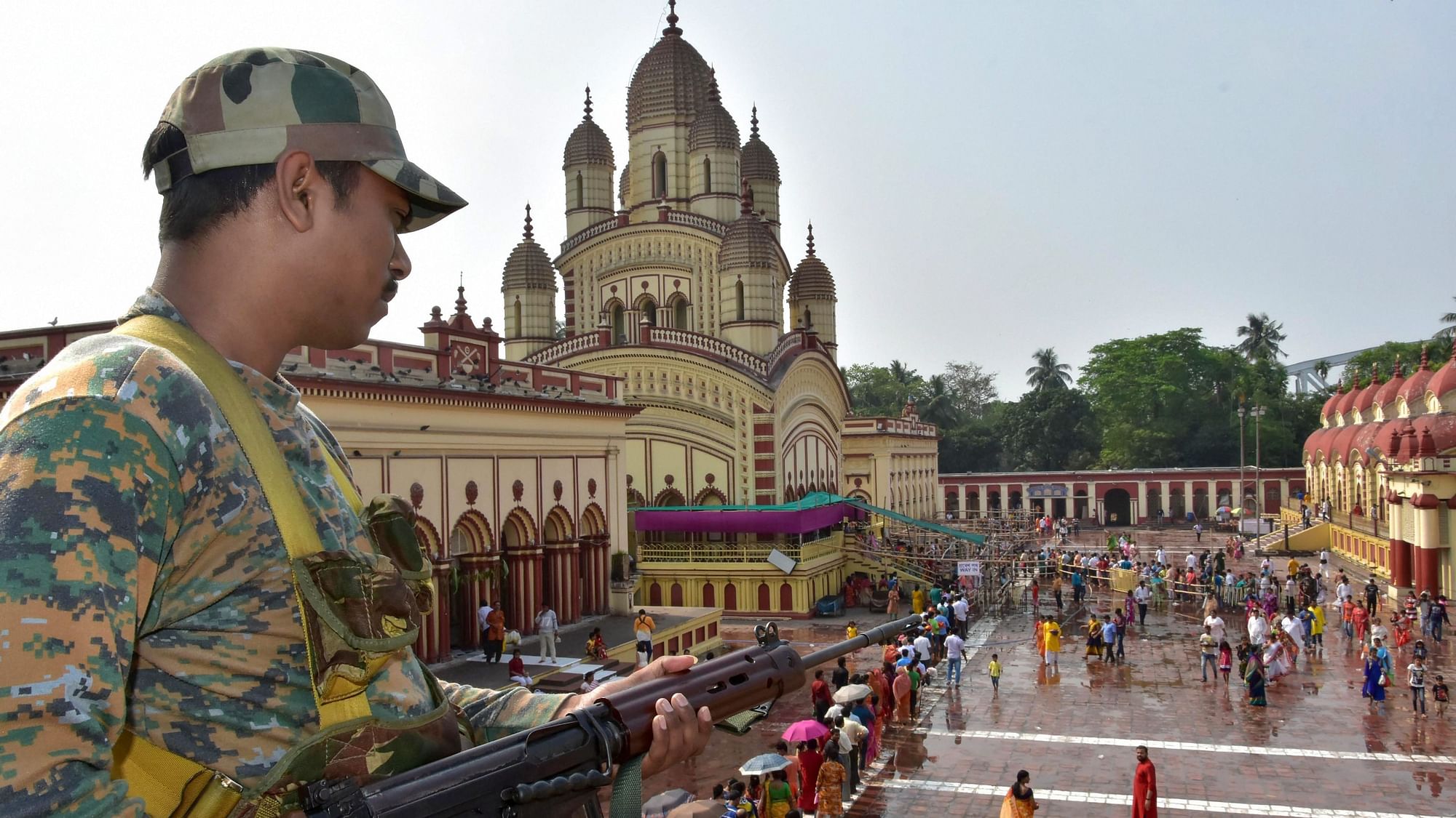A security personnel stands guard as devotees arrive at Dakshineswar Kali temple to offer prayers on Bengali New Year celebrations, in Kolkata. Image used for representational purpose only.&nbsp;