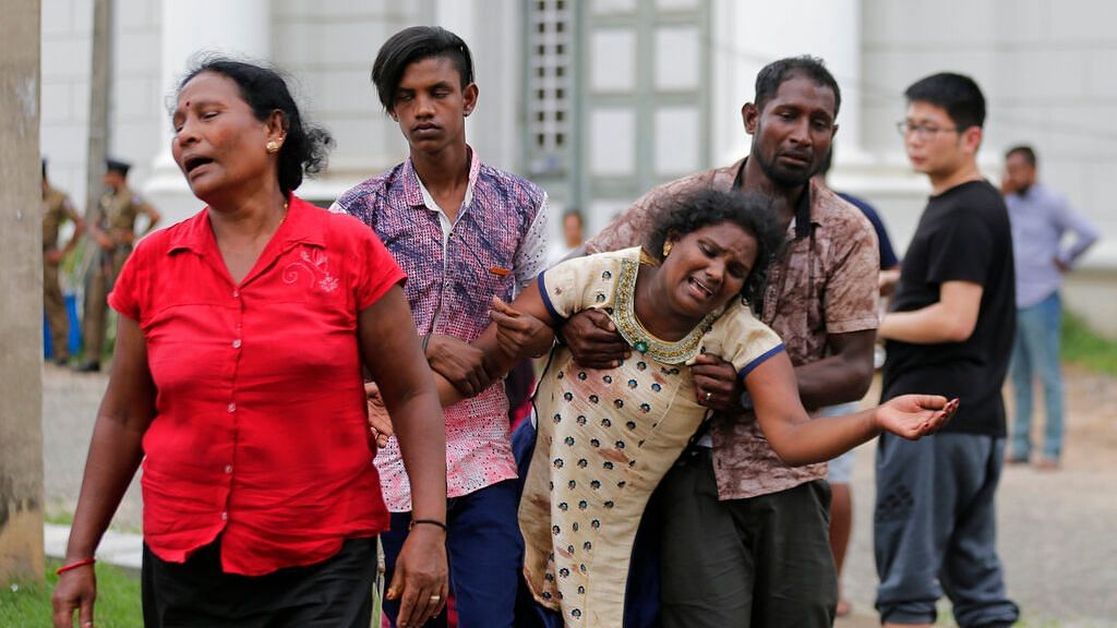 Relatives of a blast victim grieve outside a morgue in Colombo, Sri Lanka on Sunday, 21 April 2019.