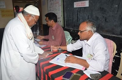 Akola (Maharshtra): A polling official administers indelible ink to a voter, at a polling station during the second phase of 2019 Lok Sabha elections in Maharashtra