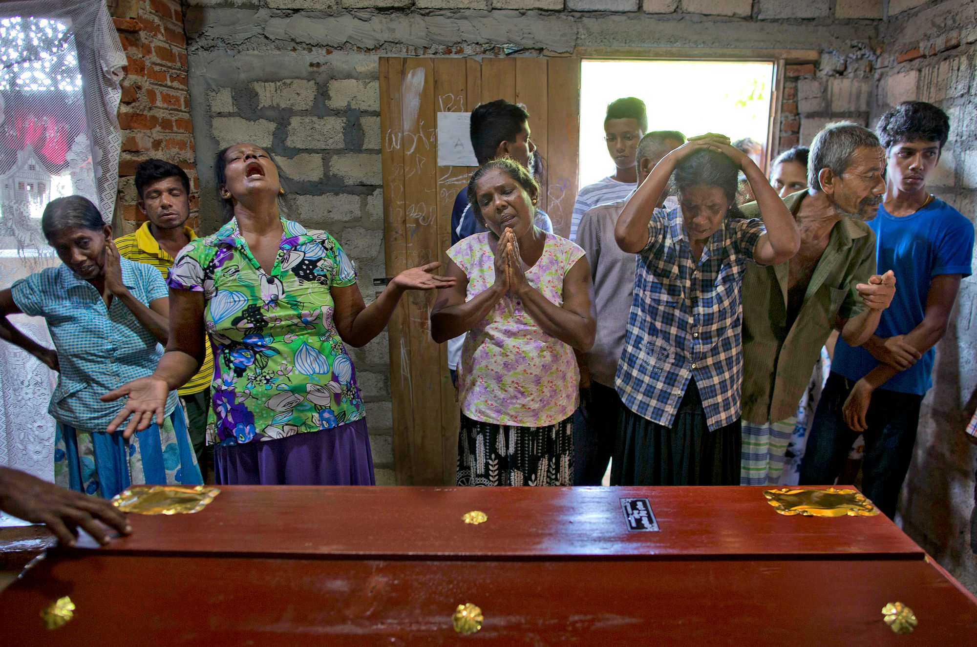 Relatives weep near the coffin carrying the remains of 12-year-old Sneha Savindi, who was a victim of the Easter Sunday bombing at St Sebastian Church in Negombo, Sri Lanka.