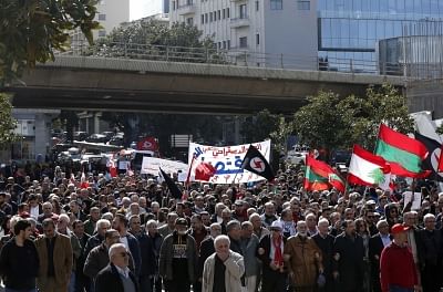BEIRUT, Feb. 17, 2019 (Xinhua) -- Protesters hold flags and banners during a protest in Beirut, capital of Lebanon, Feb. 17, 2019. Hundreds of Lebanese on Sunday protested in capital Beirut
