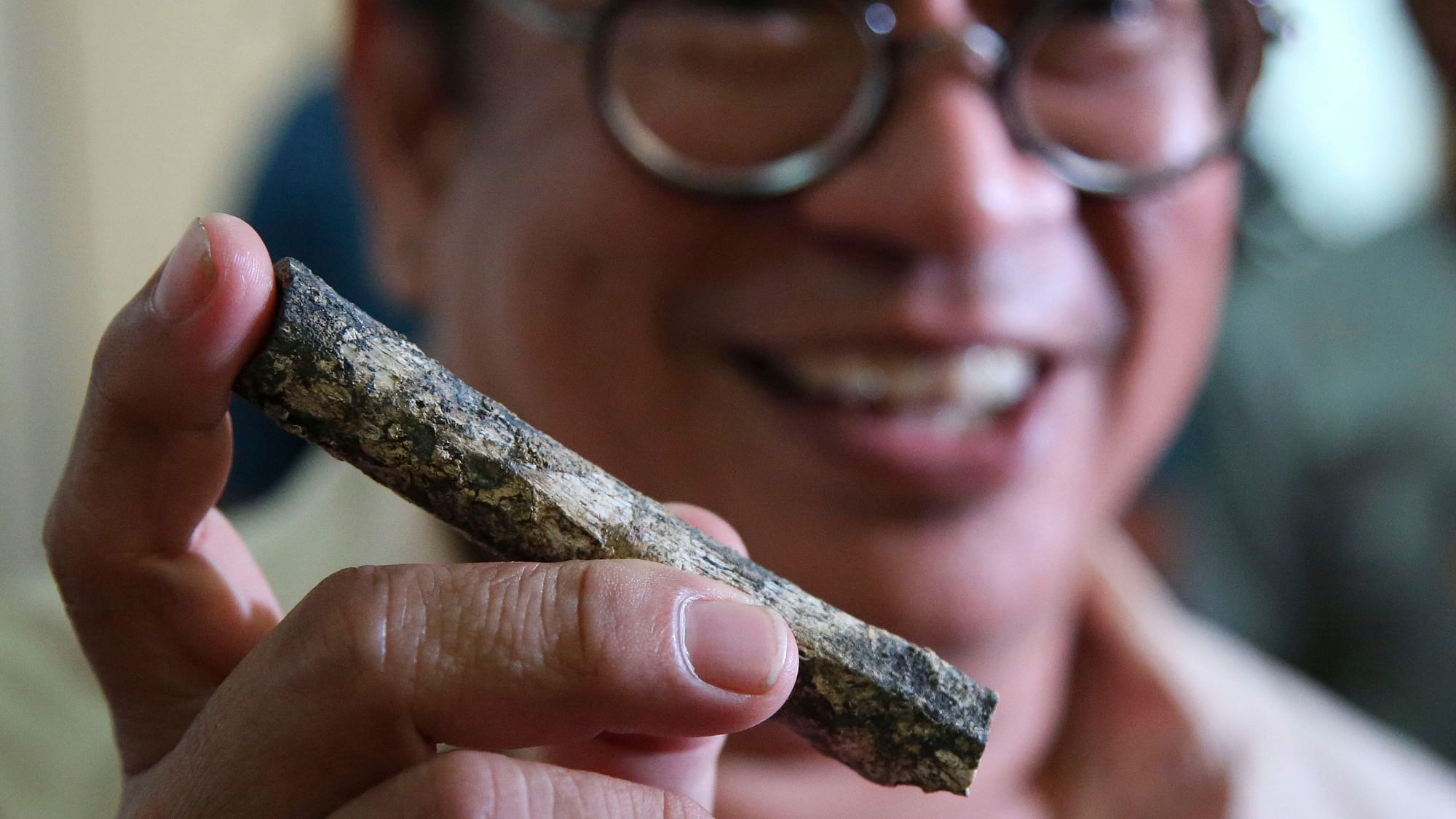 Filipino archeologist Armand Salvador Mijares shows a femur bone, one of those they recovered from Callao Cave belonging to a new specie they called Homo luzonensis.