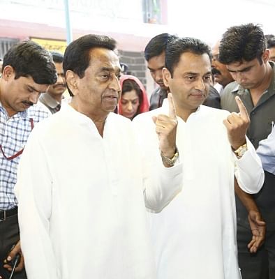 Madhya Pradesh Chief Minister Kamal Nath and his son Nakul Nath show their forefingers marked with indelible ink after casting their vote during the fourth phase of 2019 Lok Sabha elections in Shikapur of Madhya Pradesh