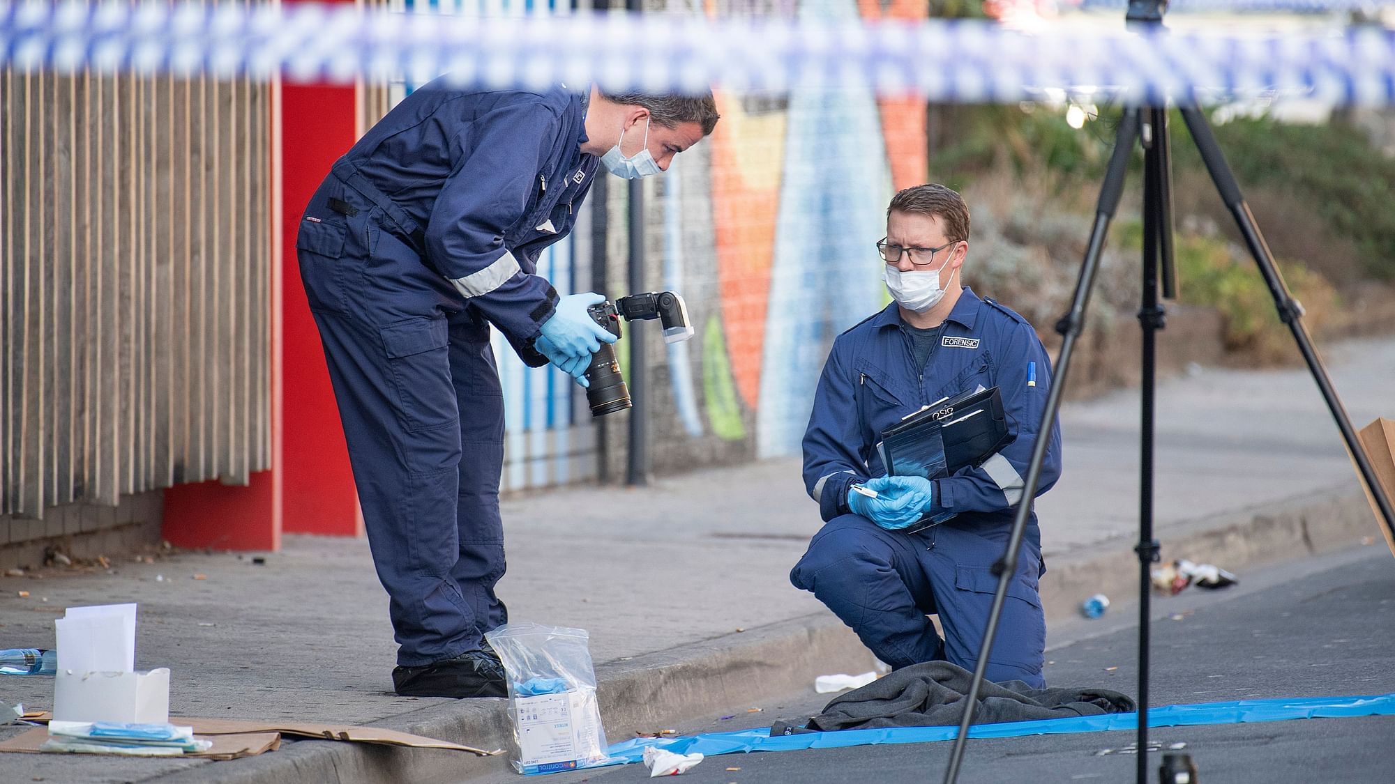 Forensic police examine items at the scene of a multiple shooting outside Love Machine nightclub in Melbourne, Sunday, 14 April, 2019.