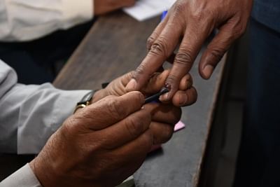 A polling official applies indelible phosphorus ink on the fore finger of a voter. (File Photo: IANS)