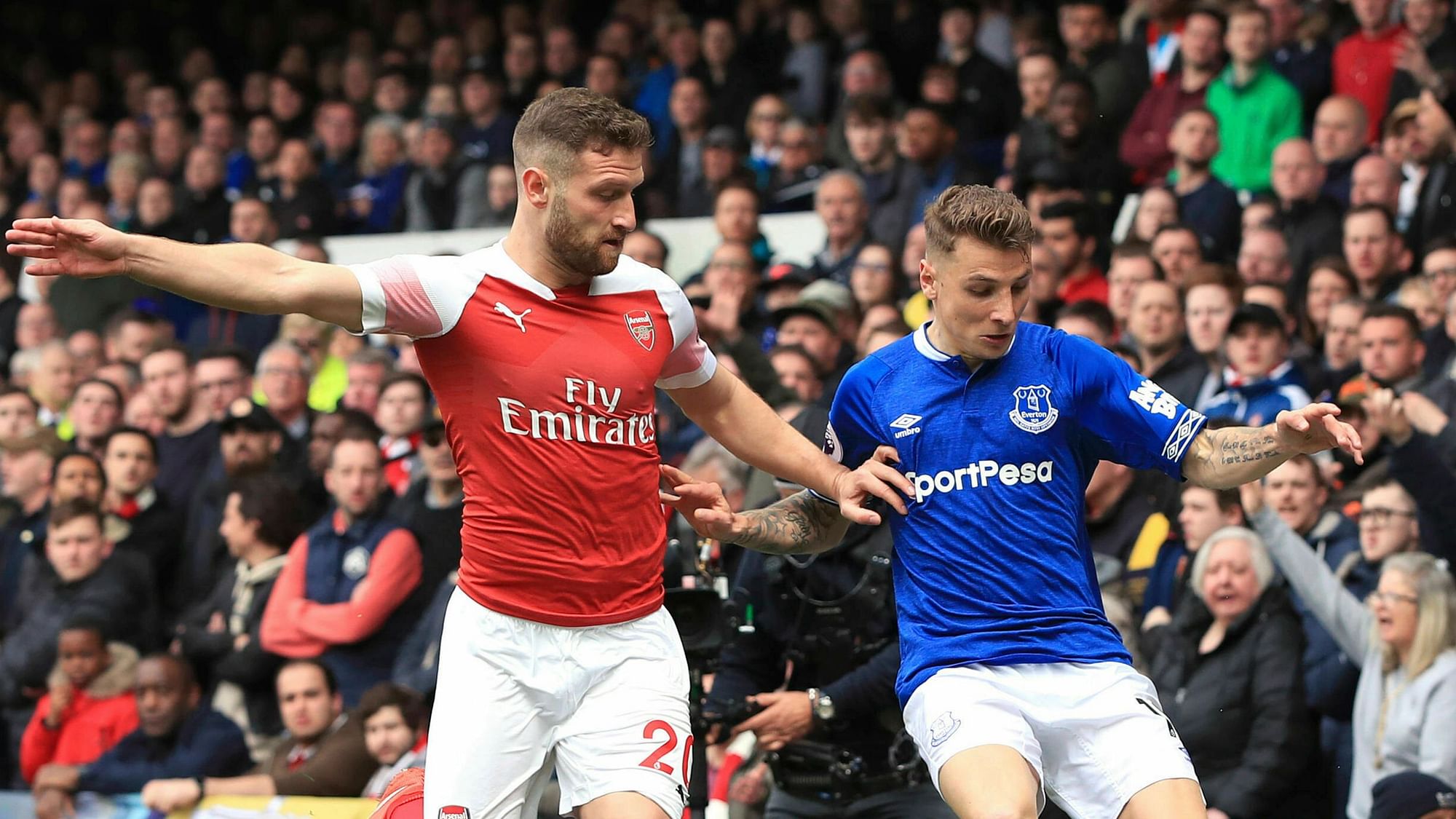 Arsenal’s Shkodran Mustafi, left, and Everton’s Lucas Digne battle for the ball during their English Premier League soccer match at Goodison Park, Liverpool, England, Sunday, April 7, 2019.&nbsp;