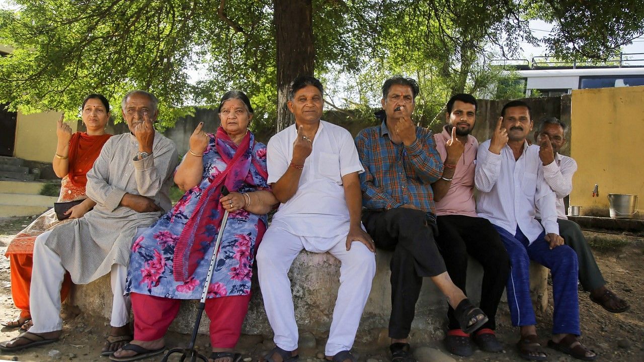 Voters in Jammu show their inked finger after casting vote for the Kulgam parliamentary seat.